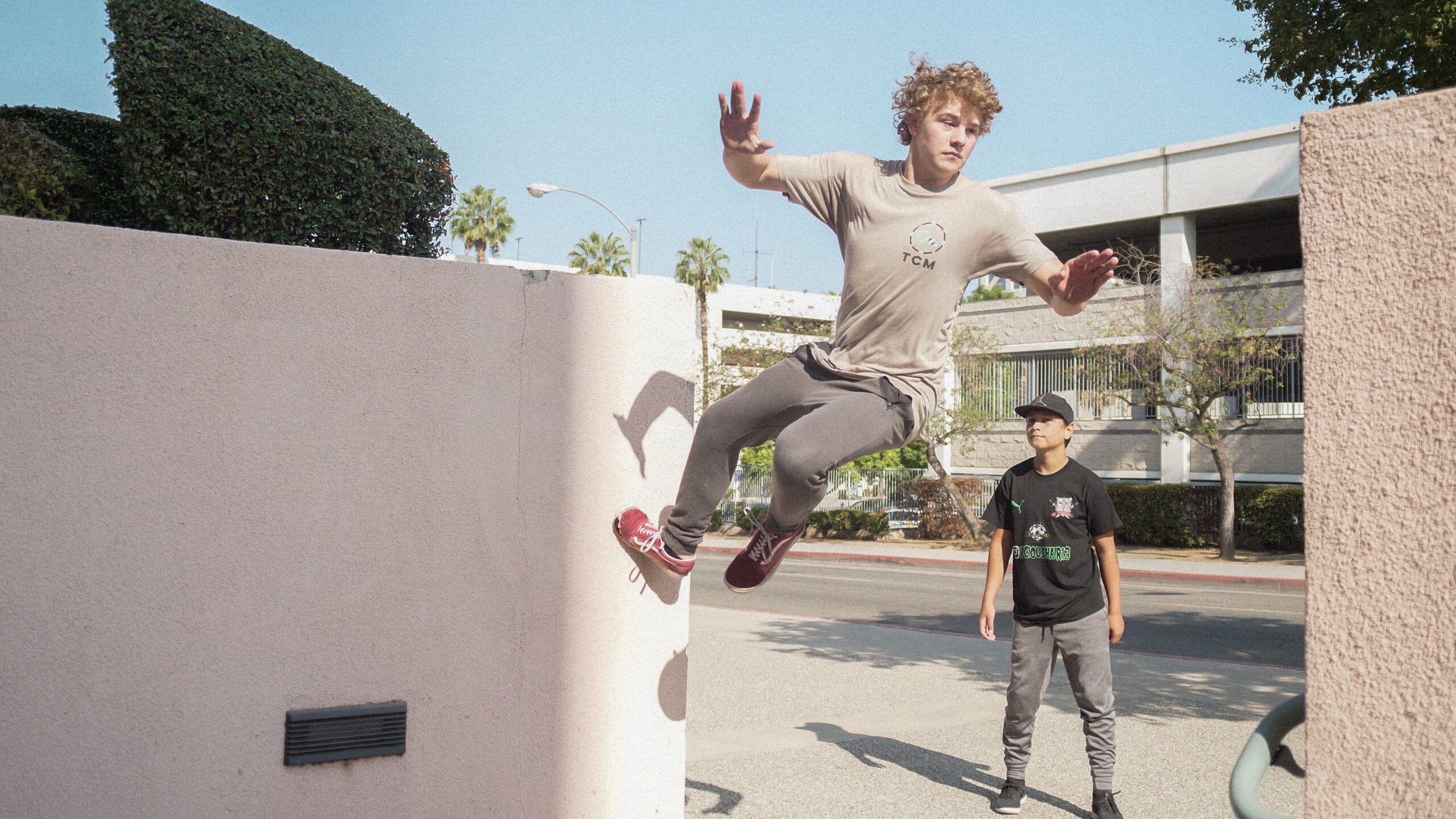 Parkour athlete mid-jump in TCM gear